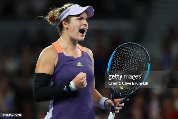 Catherine McNally of the United States of America celebrates winning match point during her Women's Singles first round match against Samantha Stosur...