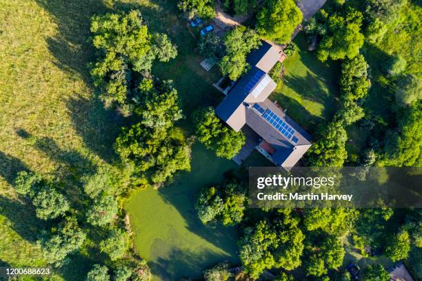 aerial view of solar panels on a rooftop of a residential home - power grid stock-fotos und bilder