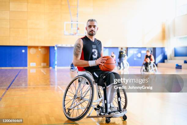 portrait of male wheelchair basketball player with ball - wheelchair basketball team stock pictures, royalty-free photos & images