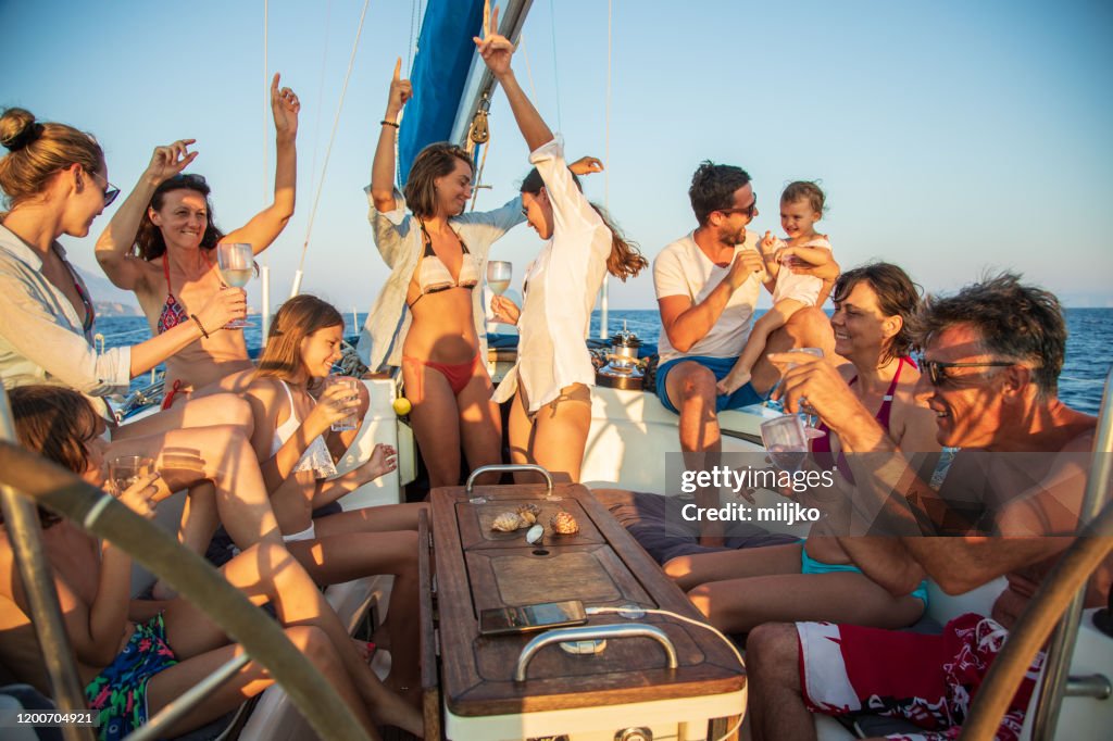 Multi generation crew on sailboat having a party