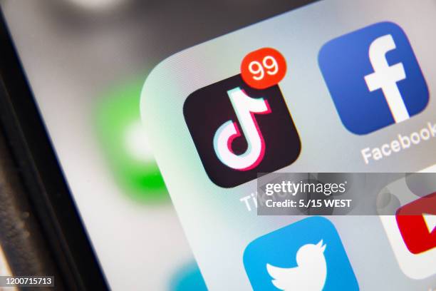 tiktok and facebook application  on screen apple iphone xr - friendship logo stock pictures, royalty-free photos & images