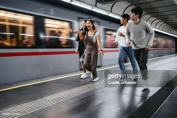 friends running for subway train - catching train stock pictures, royalty-free photos & images