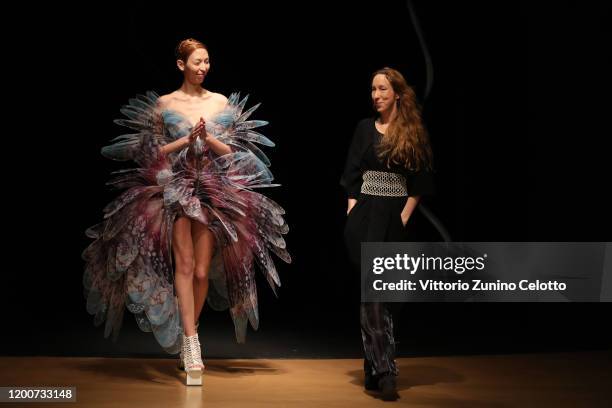 Designer Iris Van Herpen acknowledges the applause of the public after the Iris Van Herpen Haute Couture Spring/Summer 2020 show as part of Paris...