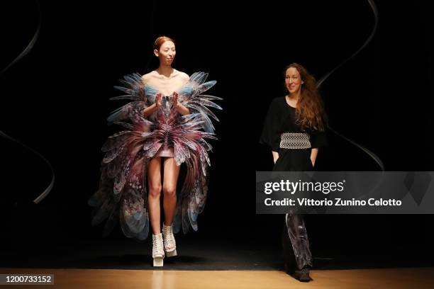 Designer Iris Van Herpen acknowledges the applause of the public after the Iris Van Herpen Haute Couture Spring/Summer 2020 show as part of Paris...