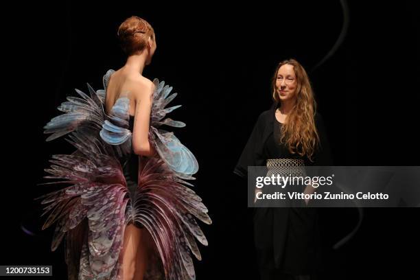 Designer Iris Van Herpen acknowledges the applause of the public after the Iris Van Herpen Haute Couture Spring/Summer 2020 show as part of Paris...