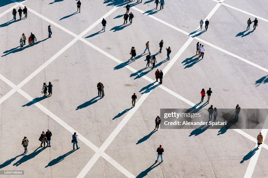 People walking at the town square on a sunny day