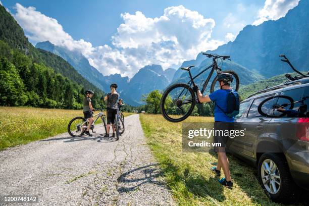 family preparing to go cycling - family cycling holiday stock pictures, royalty-free photos & images