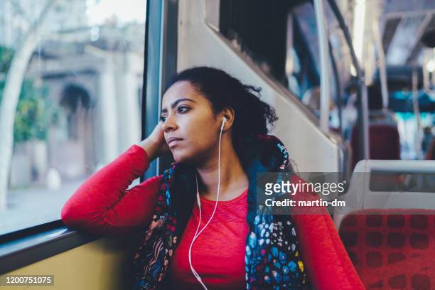mixed race woman traveling in bus - commuter bus stock pictures, royalty-free photos & images