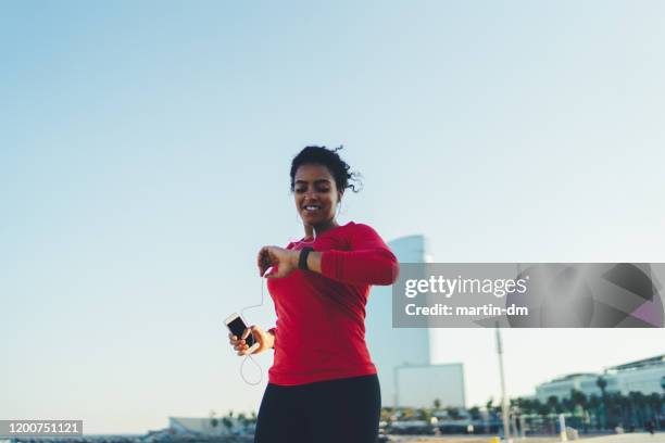 sportswoman jogging in barcelona - pedometer stock pictures, royalty-free photos & images