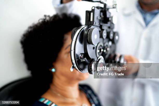 mature women on a medical appointment with ophthalmologist - eye exam stock pictures, royalty-free photos & images