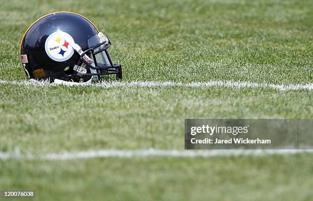 Pittsburgh Steelers helmet sits on the practice field during training camp on July 29, 2011 at St Vincent College in Latrobe, Pennsylvania.