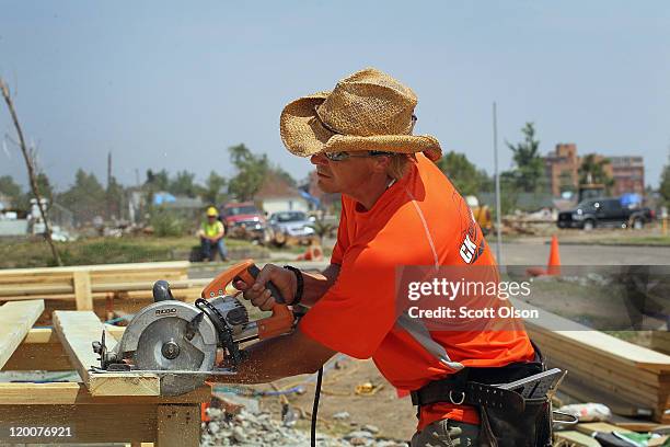 Phil Alberty with C.K. Construction helps to rebuild a home destroyed by the May 22 tornado July 29, 2011 in Joplin, Missouri. The city continues...