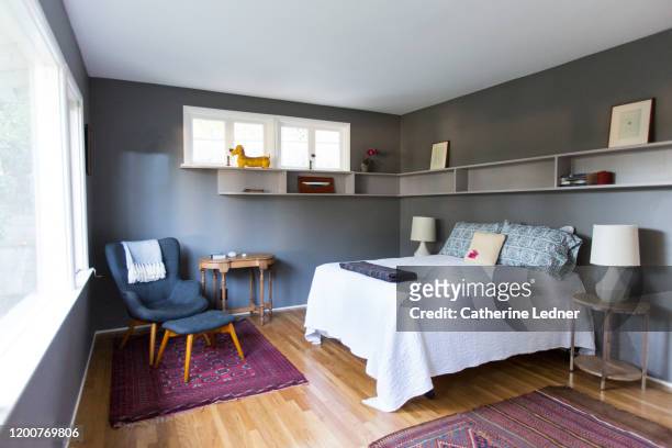 50's modern bedroom painted grey, very neat, clean and sparse. - tidy room stock pictures, royalty-free photos & images
