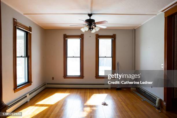 empty victorian living room with 50's baseboard heaters and ceiling fan - victorian interior stock pictures, royalty-free photos & images