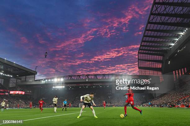 Saido Mane of Liverpool in action as the sun sets during the Premier League match between Liverpool FC and Manchester United at Anfield on January...