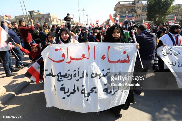 Iraqi women take part in a rally called by controversial cleric Moqtada Sadr against US presence in Iraq and calling to separate the genders in the...