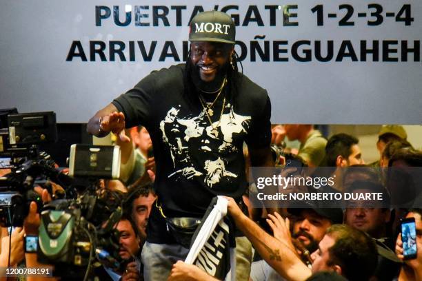 Togo's football player Emmanuel Adebayor waves to Paraguay's Olimpia football fans upon his arrival at the Silvio Pettirossi Airport on February 14,...