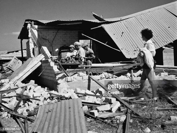 Picture dated 30 August 1948 shows members of the kibbutz Negba repairing the damages caused by air raids by the Iraq Sueidan forces during the 1948...