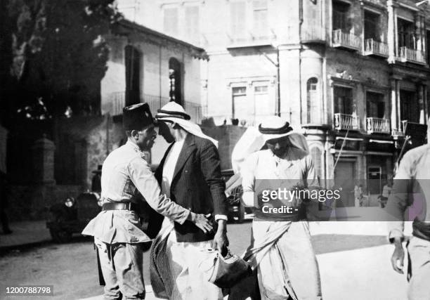 Policeman searches Palestinians in August 1929 during the British mandate in Palestine as violent clashes occurred between Arab Palestinians opposed...