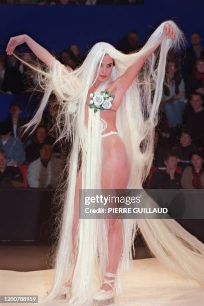 Wearing a wig, a model presents a bathing suit during French designer Jean-Paul Gaultier's Spring-Summer 1992 ready-to-wear collection, 16 October...