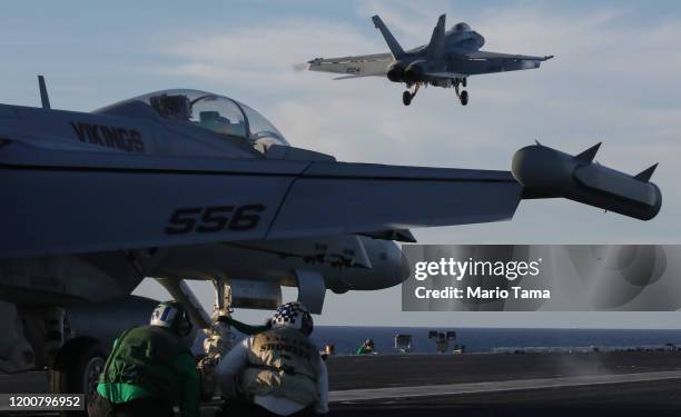 An F/A-18E Super Hornet fighter aircraft takes off from the flight deck of the USS Nimitz aircraft carrier while at sea on January 18, 2020 off the...