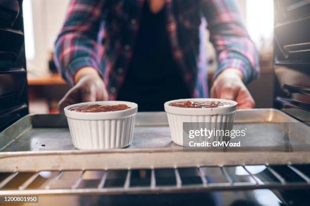 baking chocolate souffle in the oven - souffle stock pictures, royalty-free photos & images
