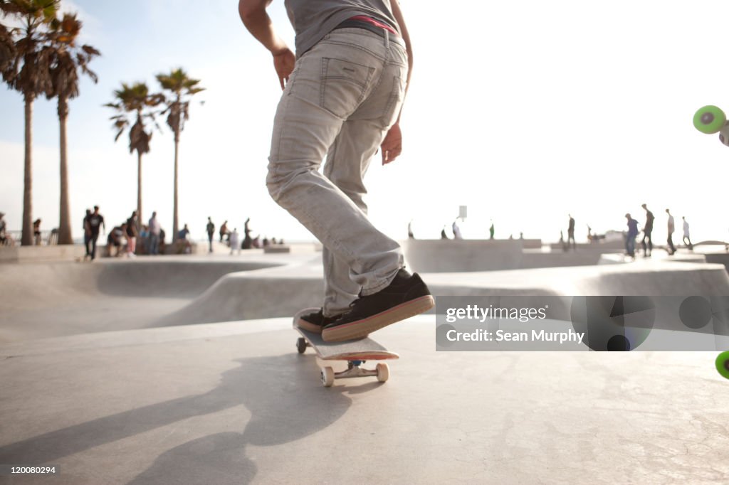 Skater about to skate down a ramp at a skatepark