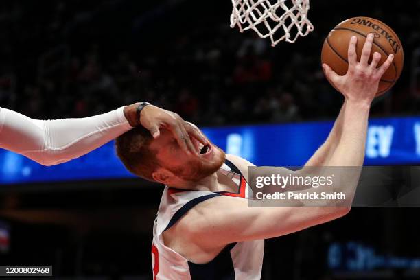 Davis Bertans of the Washington Wizards is fouled by Markieff Morris of the Detroit Pistons during the second half at Capital One Arena on January...