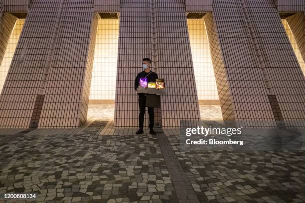 Vendor sells illuminated flower bouquets at night in the Tsim Sha Tsui district of Hong Kong, China, on Friday, Feb. 14, 2020. As fears of the novel...