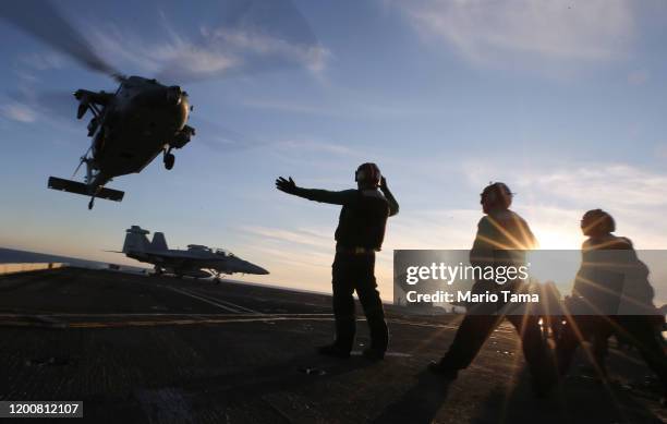 Navy helicopter departs from the flight deck of the USS Nimitz aircraft carrier while at sea on January 18, 2020 off the coast of Baja California,...