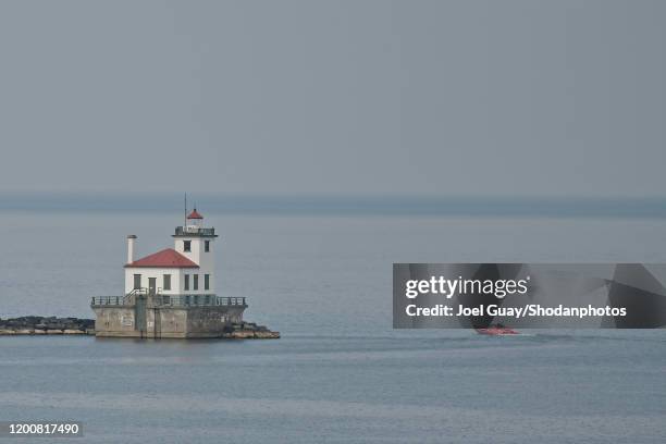 oswego west lighthouse and boat - lake ontario stock pictures, royalty-free photos & images