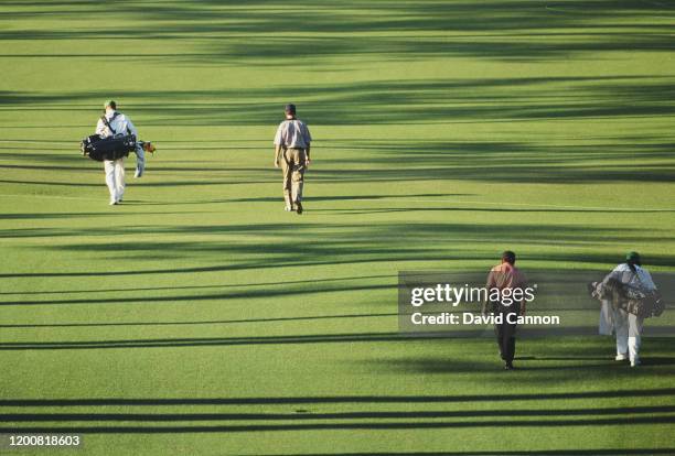 Larry Mize of the United States and Fulton Allem of South Africa and their caddies walk up the 18th hole during the US Masters Golf Tournament on 8th...