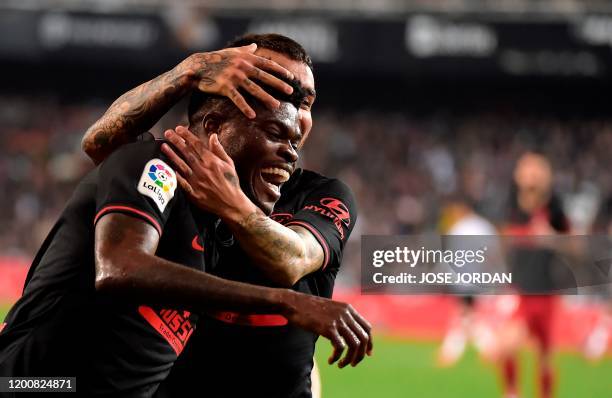 Atletico Madrid's Ghanaian midfielder Thomas Partey celebrates with Atletico Madrid's Argentine forward Angel Correa after scoring during the Spanish...