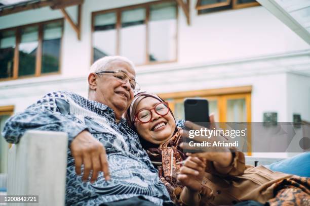 indonesian senior citizens taking a selfie - malay archipelago stock pictures, royalty-free photos & images