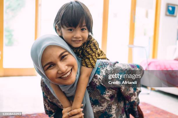 mother and son spending quality time with each other - kids fun indonesia stock pictures, royalty-free photos & images