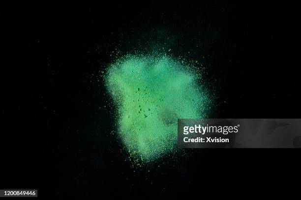 explode powder with black background captured with high speed sync. - black powder stock-fotos und bilder
