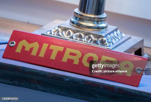 February 2020, Mecklenburg-Western Pomerania, Sülstorf: An old Mitropa sign stands in the former signal box in the station building. A Berlin taxi...