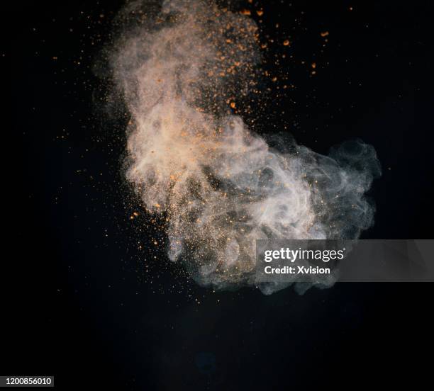 explode powder with black background captured with high speed sync."n - dust storm stock-fotos und bilder