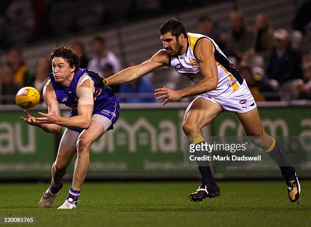 Tom Williams of the Bulldogs marks in front of Quinten Lynch of the Eagles during the round 19 AFL match between the Western Bulldogs and the West...