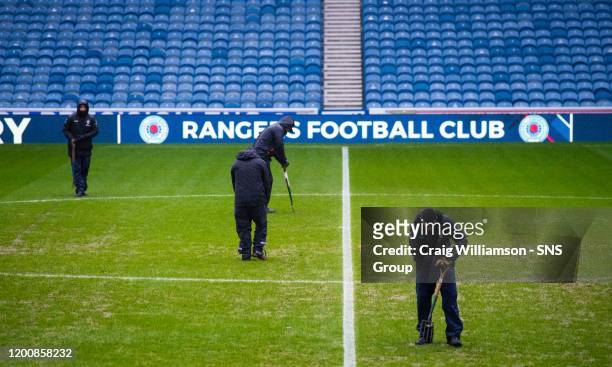 Groundman work on the pitch ahead of the Ladbrokes Premiership match between Rangers and Livingston, at Ibrox, on February 15 in Glasgow, Scotland.