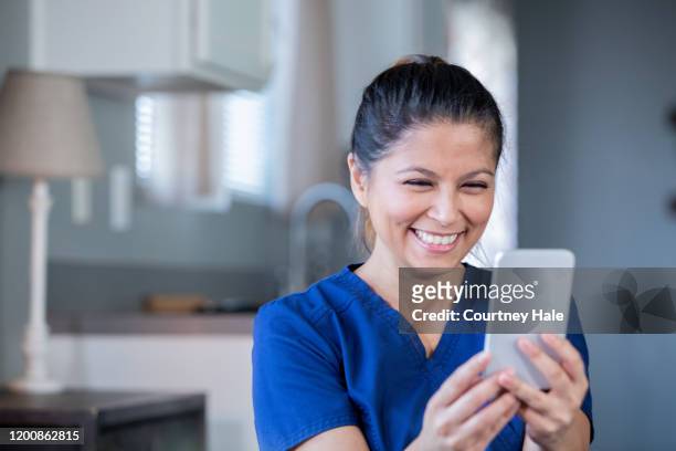 nurse or doctor video chatting with patient during appointment while working from home - philippines women stock pictures, royalty-free photos & images