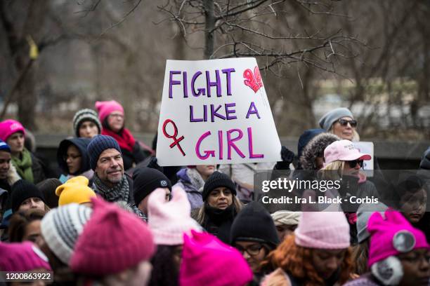 Marcher holds a sign that says, "Fight Like A Girl" with a picture of the female symbol and boxing gloves during the Woman's March in the borough of...