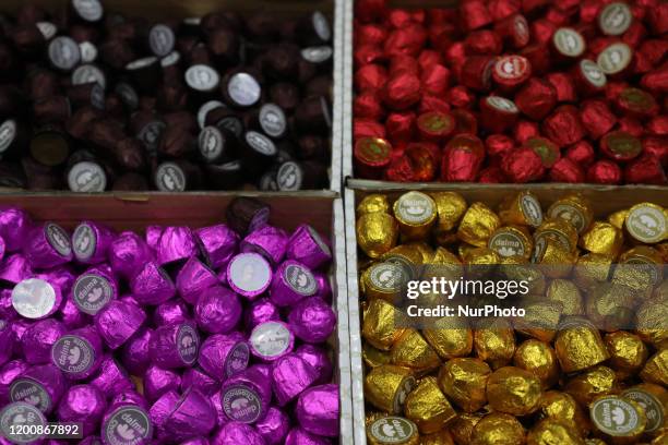 Workers wrap and pack chocolates at Alai factory in Gaza City on February 15, 2020. - Alai products are Gazan but their components are not, as few of...