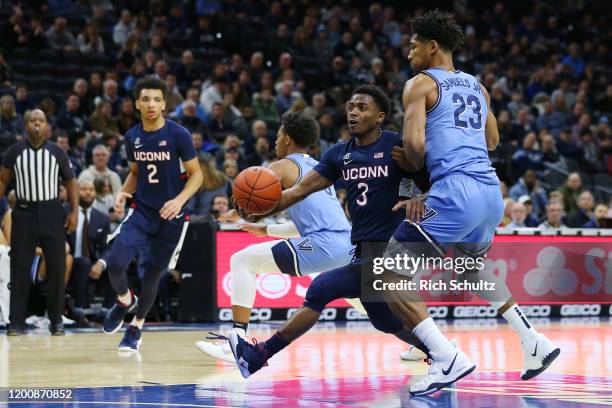 Alterique Gilbert of the Connecticut Huskies in action against Jermaine Samuels of the Villanova Wildcats during a college basketball game at Wells...