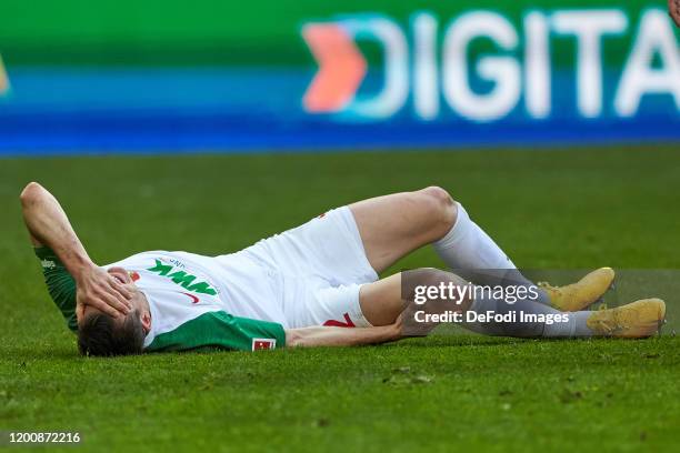 Stephan Lichtsteiner of FC Augsburg injured during the Bundesliga match between FC Augsburg and Sport-Club Freiburg at WWK-Arena on February 15, 2020...