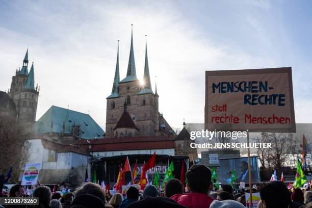 Demonstrators hold a poster that reads "human rights instead of right wing people" as they rally for a protest themed "Not with us! No pacts with...