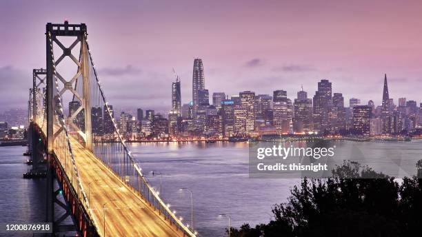 san francisco financial district. bridge. tree. sunset time. - san francisco bay stock pictures, royalty-free photos & images