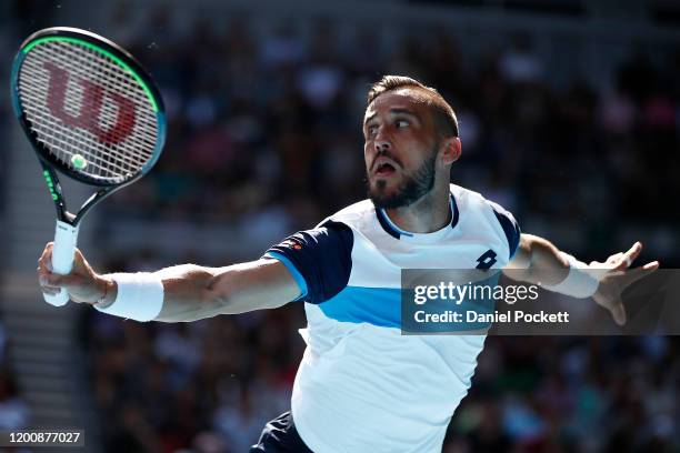 Damir Dzumhur of Bosnia and Herzegovina plays a backhand during his Men's Singles first round match against Stan Wawrinka of Switzerland on day two...