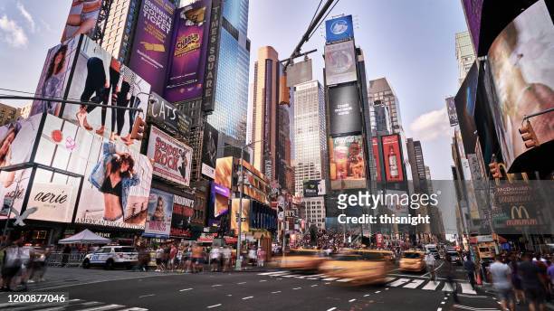 blurred motion at times squares. advertising. crowded. - times square manhattan stock pictures, royalty-free photos & images