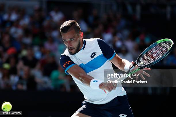 Damir Dzumhur of Bosnia and Herzegovina plays a backhand during his Men's Singles first round match against Stan Wawrinka of Switzerland on day two...
